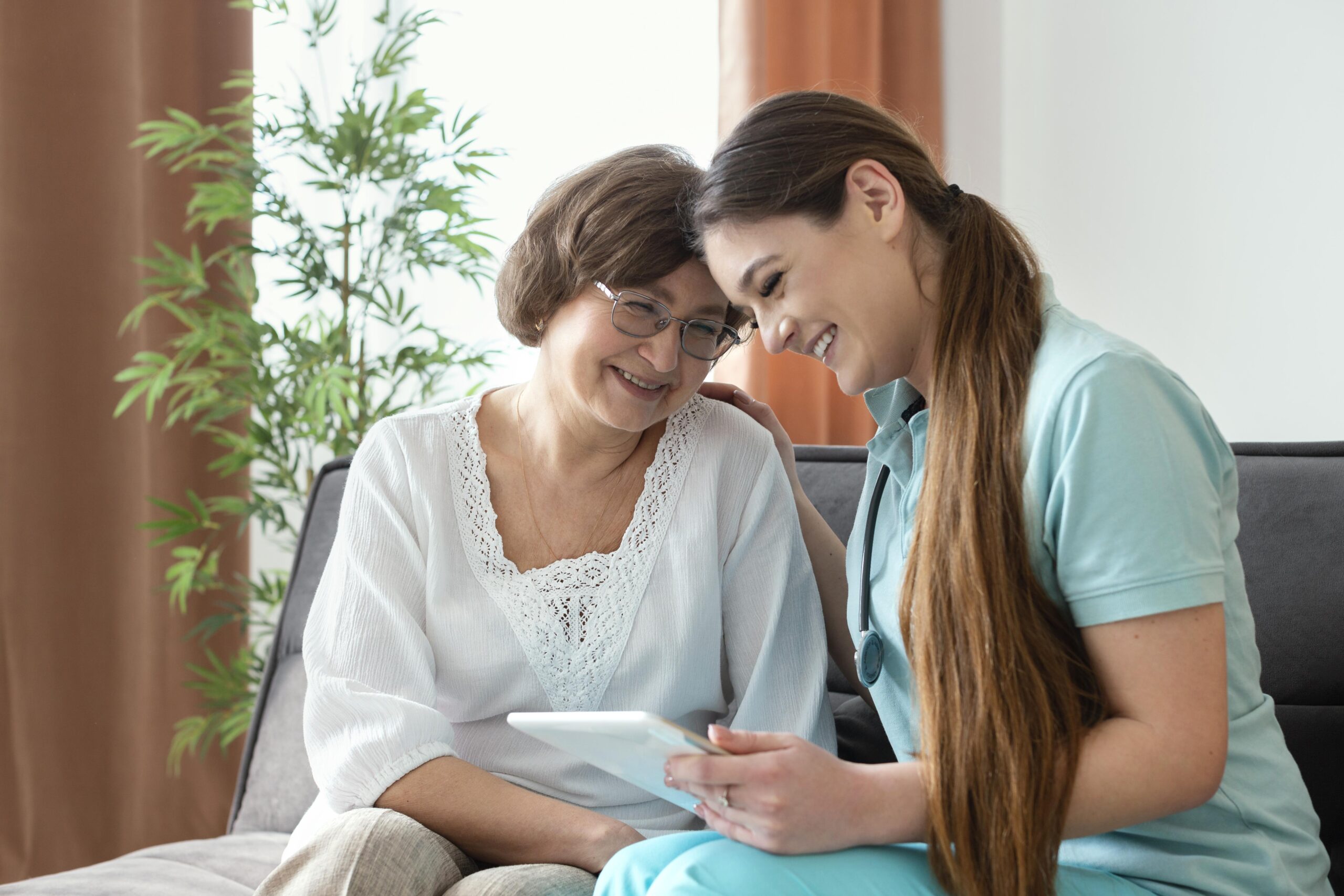 women-looking-tablet-medium-shot